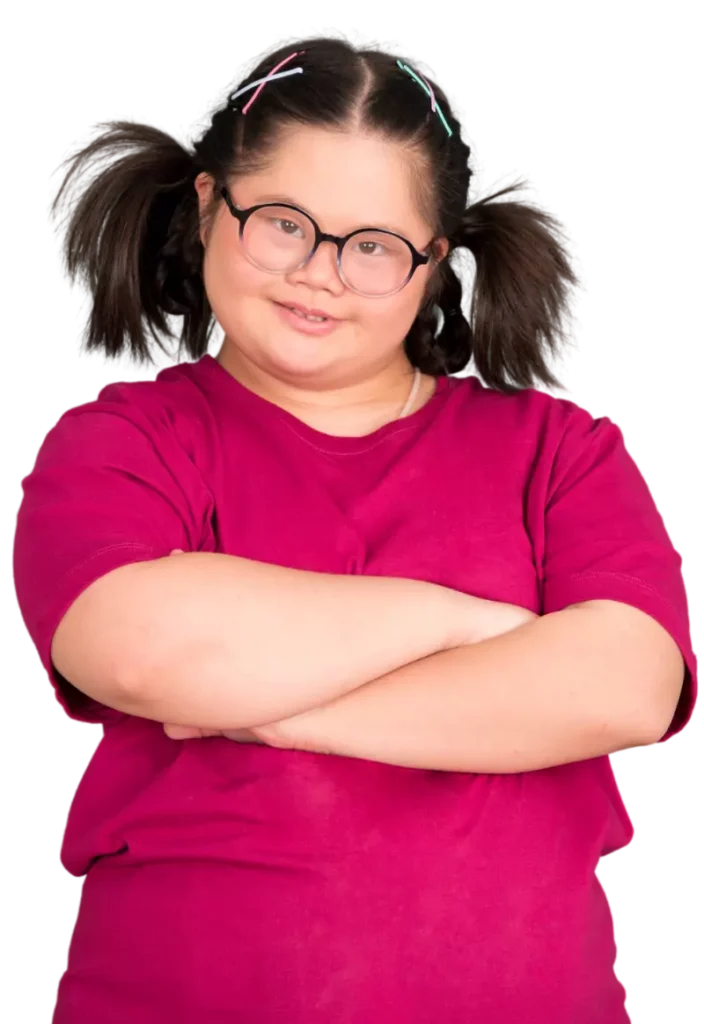 Girl with disability in pink tshirt with arms crossed smiling at camera