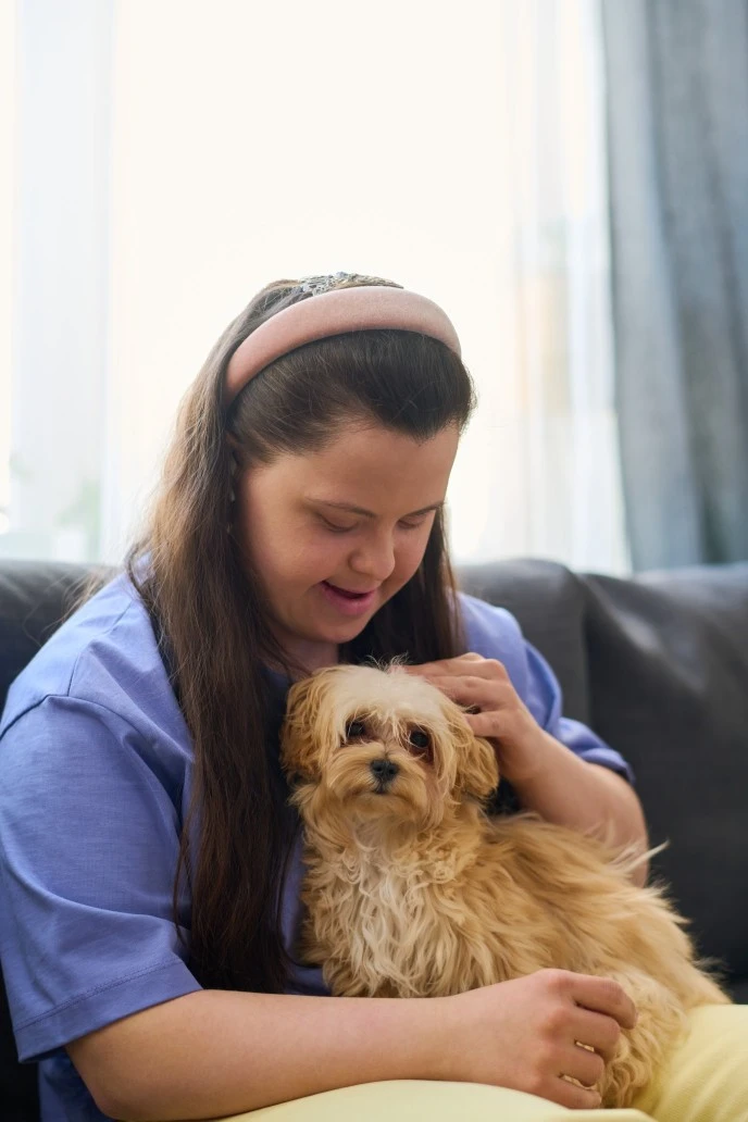 Girl with down syndrome patting her dog