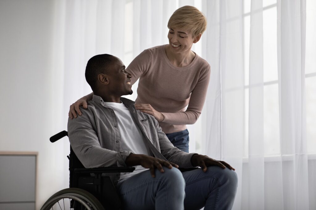 Carer with man in wheelchair